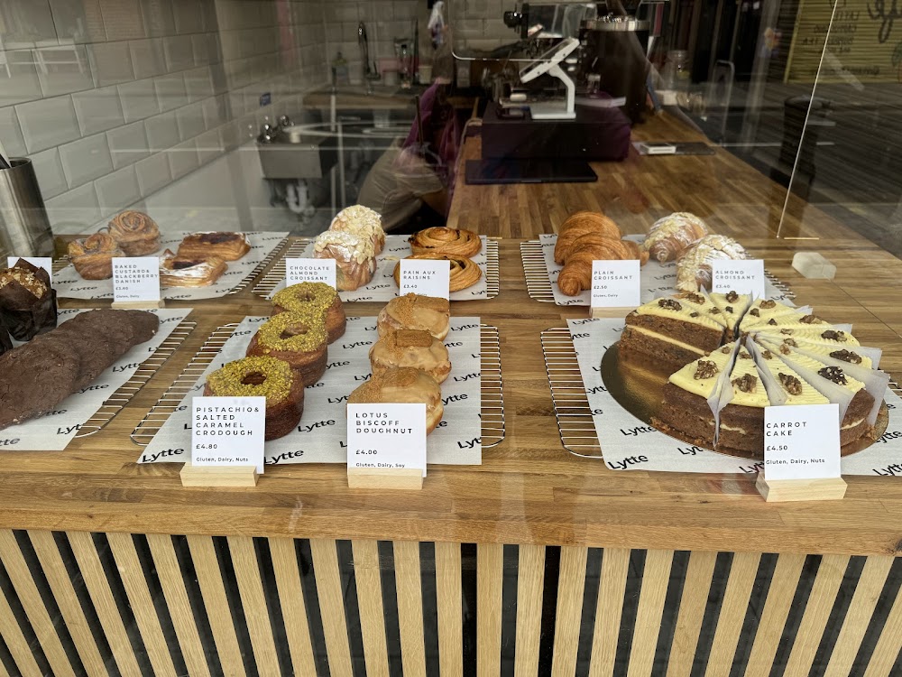 Counter pastry display with croissants, doughnuts and cake